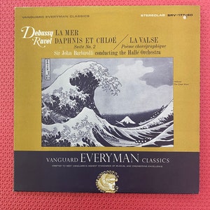 May include: A vintage vinyl record album cover featuring the artwork of "The Great Wave off Kanagawa." The album includes the musical compositions "La Mer," "Daphnis et Chloé," and "La Valse." The album is part of the Vanguard Everyman Classics series.
