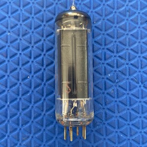 May include: A vintage vacuum tube with a clear glass enclosure and a metallic top. The internal components are visible, including vertical plates and connecting wires. The tube has gold-colored pins at the base, designed for insertion into a socket.