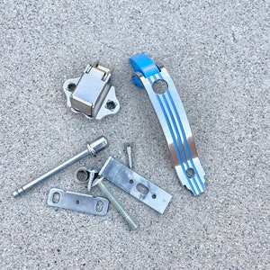 May include: A silver metal latch with a blue and silver metal handle, along with several screws and metal brackets.
