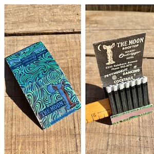 May include: Vintage matchbook cover with a psychedelic design featuring a blue and green swirl pattern and a white silhouette of a dog. The cover reads "The Moon Rooftop Waikiki Outrigger Hotel 2335 Kalakaua Avenue Phone 923-0711 Psychedelic Dancing Cocktails".