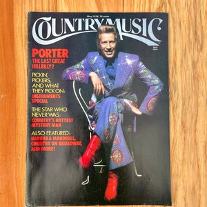 May include: A vintage magazine cover featuring a country music star wearing a sparkly blue suit and red cowboy boots. The cover reads "Country Music" and features the headline "Porter: The Last Great Hillbilly?"