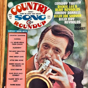 May include: A vintage Country Song Roundup magazine cover featuring a man playing a trumpet. The cover features the text "Country Song Roundup" and lists Conway Twitty, Dickie Lee & Alan Reynolds, Johnny Darrell, Billy Joe Shaver, and Billy Ray Reynolds as featured artists.