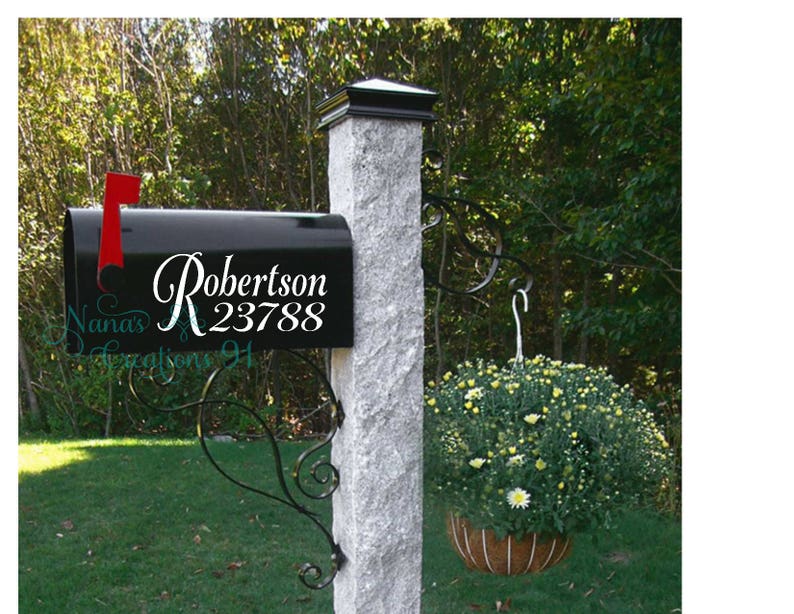 May include: Black mailbox with a white vinyl decal that says "Robertson 23788". The mailbox is mounted on a gray stone post with a black metal mailbox holder.