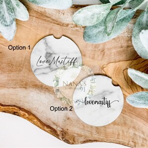 May include: Two white marble coasters with black text. The first coaster says "Love Mastiff" and the second coaster says "lovemastiff".