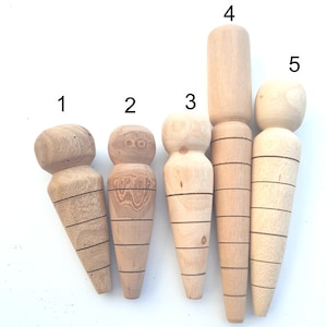 May include: Five wooden plant watering spikes in different sizes and shapes. The spikes are made from natural wood and have a light brown colour. They are designed to help water plants evenly and efficiently.