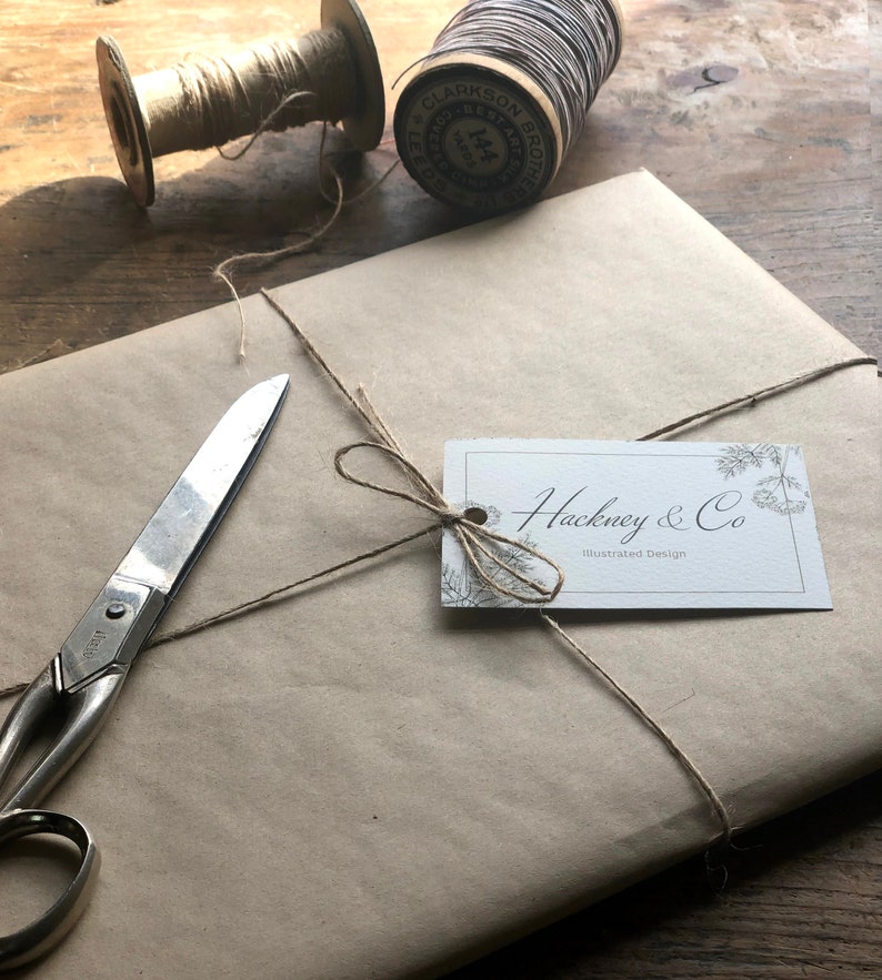 May include: A brown paper package tied with twine and a white gift tag that reads "Hackney & Co. Illustrated Design".