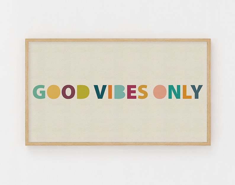 May include: A framed print with the text "GOOD VIBES ONLY" in colorful letters on a beige background.