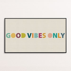 May include: A framed print with the text "GOOD VIBES ONLY" in colorful, rounded letters on a beige background.