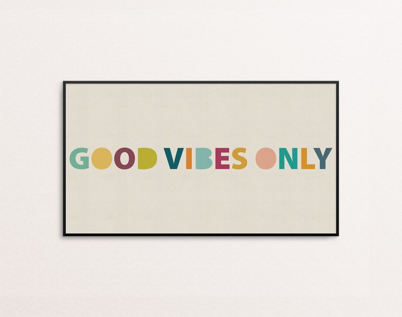 May include: A framed print with the text "GOOD VIBES ONLY" in colorful, rounded letters on a beige background.