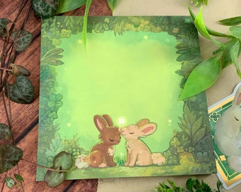 Notepad representing two cute rabbits surrounded by clovers - squared paper, cute stationery