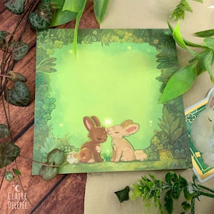 Notepad representing two cute rabbits surrounded by clovers - squared paper, cute stationery