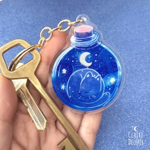 Cute cat sleeping potion keychain : acrylic charm of a space cat - animal lover gift, cute keychain, cute charm
