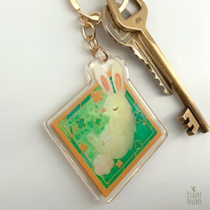 Cute Rabbit Keychain : a Sleeping Bunny in a Gold Frame, With Clovers ...