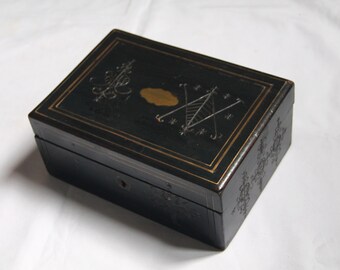 Vintage wooden box carved with voodoo patterns