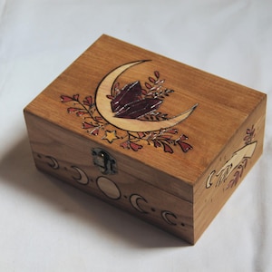 Wooden box carved with nature and magic patterns