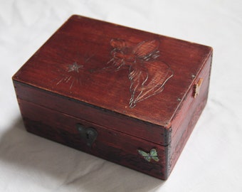 Vintage wooden chest carved with fairies and foliage patterns