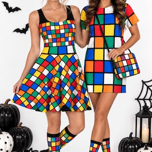 May include: Two dresses featuring a colorful grid pattern of red, blue, green, yellow, and white squares. One is a sleeveless skater dress, the other a short-sleeve shift dress. Both include matching socks, a headband, and a crossbody bag.