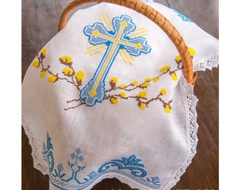 May include: White linen Easter basket liner with an embroidered cross in blue and yellow, and willow branches. The liner has a lace trim.