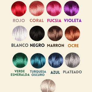 May include: A color chart of silk thread spools in various colors, including red, coral, fuchsia, violet, white, black, brown, ochre, emerald green, turquoise, blue, silver, and cream. The chart is titled "Carta de Colores Seda".