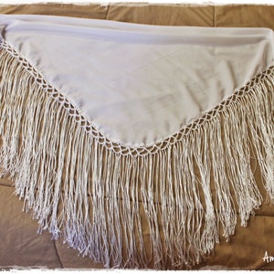 May include: White shawl with a crocheted border and long fringe. The shawl is made of a lightweight fabric and is perfect for adding a touch of elegance to any outfit.