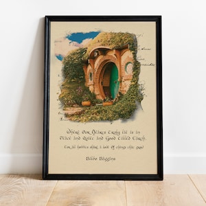 May include: Framed art print featuring a hobbit hole with a green door, surrounded by lush greenery and brickwork. The print includes a quote from Bilbo Baggins in elegant script, set against a parchment-like background.