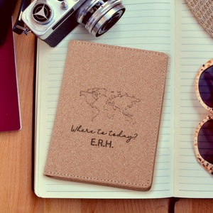 May include: Cork passport holder with a world map and the text "Where to today? E.R.H." engraved on the front.
