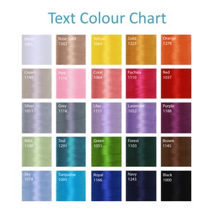 May include: A color chart with thread samples in various colors, including white, rose gold, yellow, gold, orange, cream, pink, coral, fuchsia, red, silver, grey, lilac, lavender, purple, mint, teal, green, forest, brown, sky, turquoise, royal, navy, and black. Each color sample is labeled with a color name and a corresponding number.
