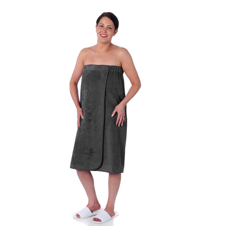 May include: A dark gray wrap towel with a tie closure. The towel is made of soft, absorbent material and is perfect for use after a shower or bath.