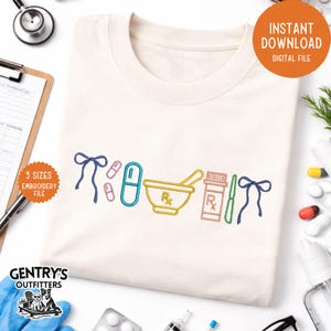 May include: A cream-coloured t-shirt featuring embroidered pharmacy-themed designs in various colours. The design includes a mortar and pestle, pills, a prescription bottle, and a bow. The shirt also has the text "3 sizes embroidery file" and "Instant Download Digital File".