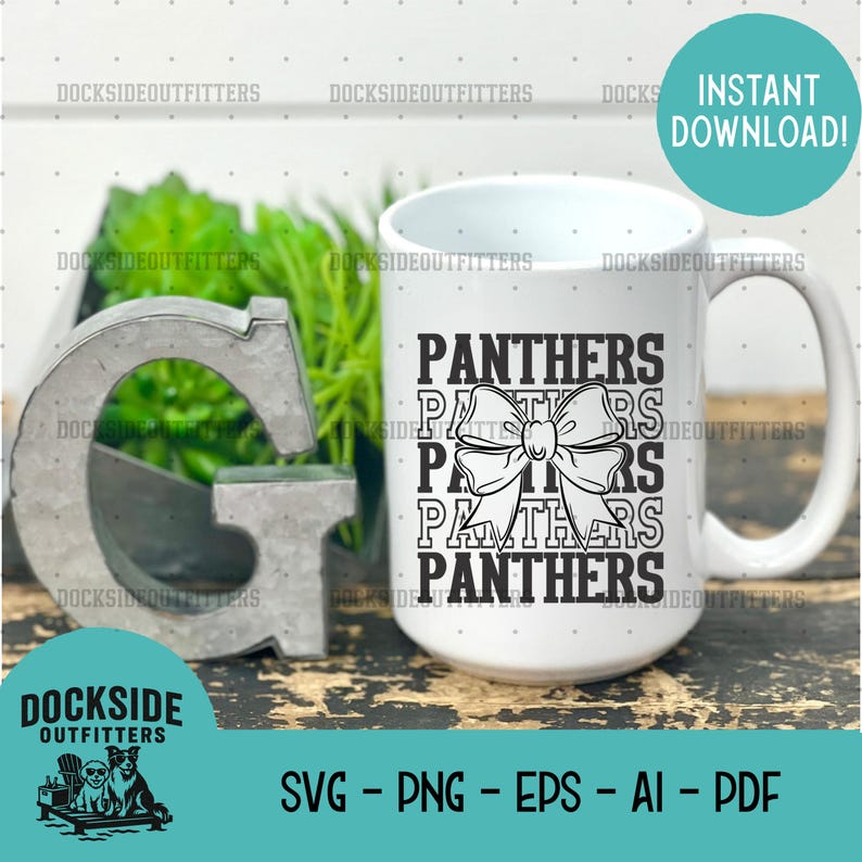 A white mug with the word "Panthers" printed on it, along with a decorative metal letter "G" and a plant in the background.
