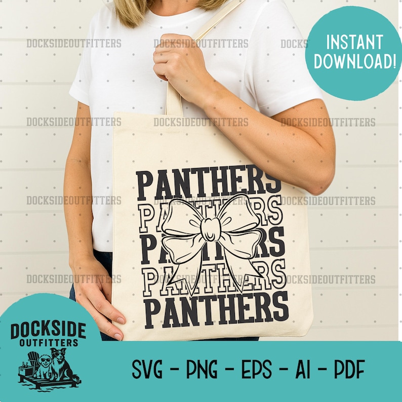 A person is holding a white tote bag with a black graphic design featuring the word "Panthers" in a large font, with a bow-like element.