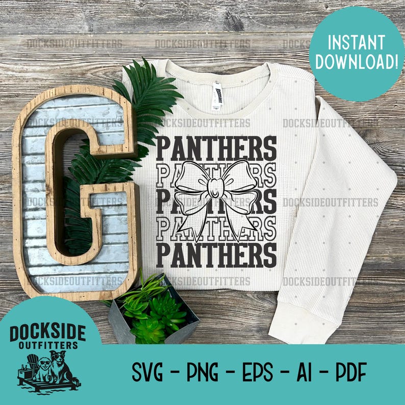 a white sweater with the word "PANTHERS" printed on it, along with a decorative letter "G" and some greenery. The image also includes a plant and a wooden letter "G" on a wooden surface.