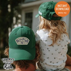 May include: A dark green baseball cap featuring a patch with the text SUPPORT YOUR LOCAL GIRL DAD in white lettering. The cap has a structured crown, a curved brim, and an adjustable strap at the back. The design is simple and functional.