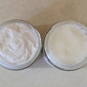 May include: Two glass jars, one filled with a white creamy substance and the other filled with a white grainy substance.