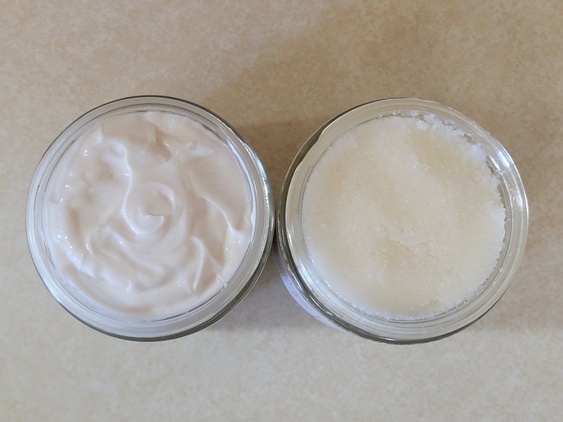 May include: Two glass jars, one filled with a white creamy substance and the other filled with a white grainy substance.