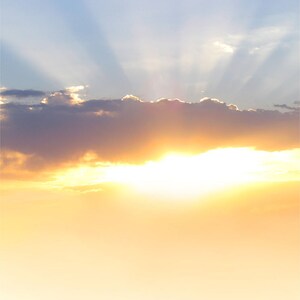 May include: A bright, golden sunset with a single cloud in the sky. The sun is shining through the cloud, creating a radiant glow.