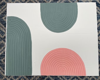 May include: Abstract art painting with three half-circle shapes. The top shape is teal green, the bottom shape is pink, and the left shape is a darker teal green.