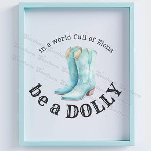 May include: A light blue framed print with the text "in a world full of Elons be a DOLLY" and a pair of light blue cowboy boots.