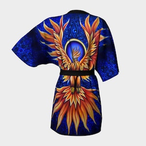 May include: A blue and orange kimono robe featuring a phoenix design. The phoenix is encircled by a circle and has a blue background. The robe has a black sash.