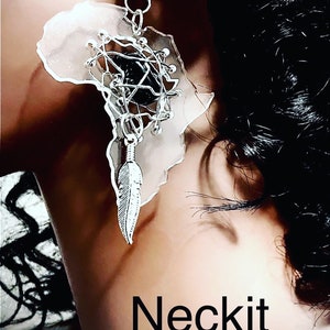 May include: A silver earring with a clear plastic outline of the continent of Africa. The earring features a black gemstone in the center of a silver wire design and a silver feather charm.