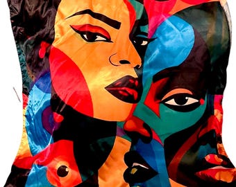 May include: A square satin scarf featuring a vibrant, multi-colored graphic print of three stylized faces. The design incorporates bold blocks of orange, black, blue, red, and teal, with sharp black outlines defining the facial features.
