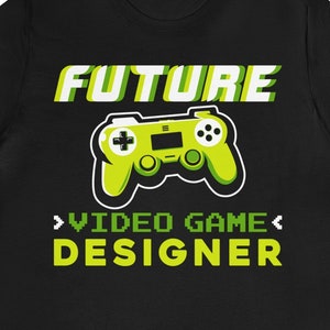 May include: Black t-shirt with a green and yellow video game controller graphic and the text "FUTURE VIDEO GAME DESIGNER".