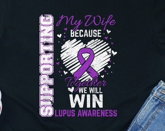 May include: Black t-shirt with a purple ribbon and the text "Supporting My Wife Because Together We Will Win Lupus Awareness".