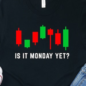 May include: Black t-shirt with a green and red stock chart graphic and the text "Is it Monday yet?"