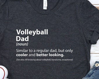 May include: A dark gray t-shirt with white text that reads "Volleyball Dad (noun) Similar to a regular dad, but only cooler and better looking. (See also: All knowing about volleyball, handsome, exceptional)"