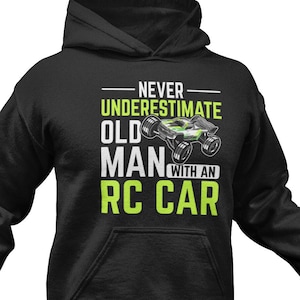 May include: Black hooded sweatshirt with a white graphic that says "Never underestimate old man with an RC car". The graphic also includes a green and black RC car.