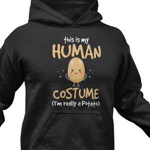 May include: Black hoodie with a potato character and the text "This is my human costume (I'm really a potato)".