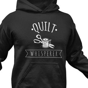 May include: Black hoodie with a white graphic that says "Quilt Whisperer" with a pair of scissors and a spool of thread.