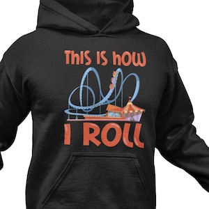 May include: Black hooded sweatshirt with the text "This is how I roll" in orange and a blue roller coaster graphic.