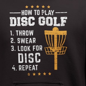 May include: Black hoodie with a distressed gold graphic that says "How to Play Disc Golf" with a list of steps: "1. Throw, 2. Swear, 3. Look for Disc, 4. Repeat".